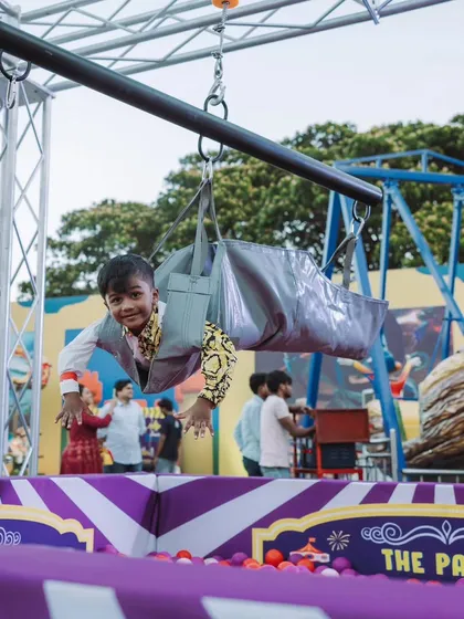 The birthday boy himself having a blast on a zipline over a ball pit. I design events with thrilling activities that create unforgettable, action-packed memories.