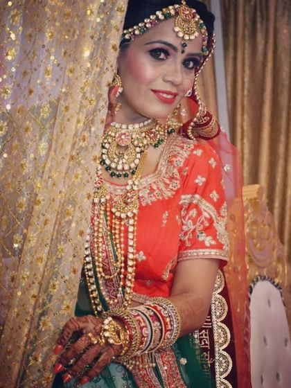 A beautiful bride peeking from behind a curtain. She is adorned in a complete bridal set with a choker, a long rani haar, and matching accessories.
