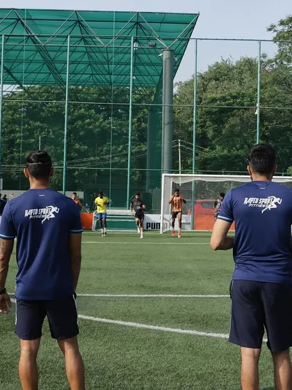 Coaches observing an off-season training session.