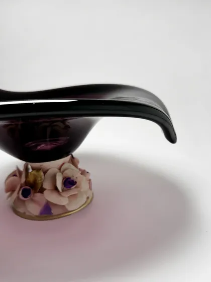 A side view highlighting the elegant curve of the amethyst Murano bowl and the intricate detail of its floral base. It is a piece that is beautiful from every single angle.