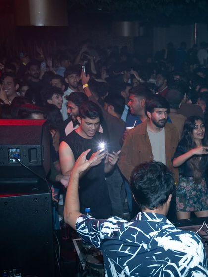 A view from behind the console at Magique, Bangalore, showing a packed and joyful dancefloor.
