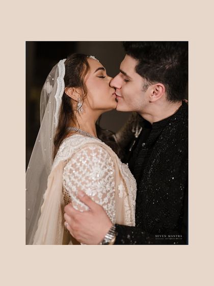 A gentle kiss, a timeless moment. This intimate shot is a beautiful close-up of the couple's affection.
