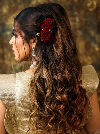 A detailed look at this gorgeous hairstyle with soft waves and red rose accents. This style adds a touch of romance and color to any party or wedding look.