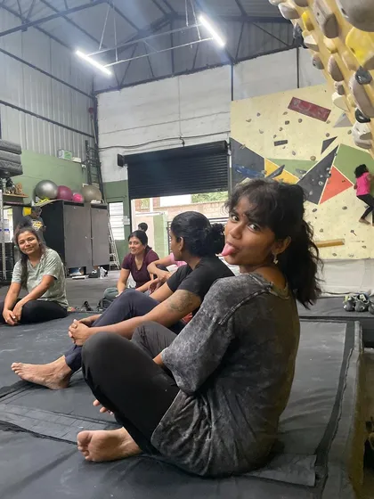 The best part of bouldering is the time spent resting and figuring out problems with your friends. Here's a moment of fun between climbs.