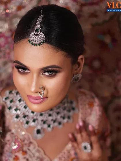 An overhead shot that captures the full effect of the makeup and the stunning diamond and emerald maang tikka.