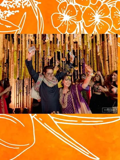 The happy couple celebrating during their Haldi ceremony, showering each other with flower petals under the traditional hanging marigold decor. These are the moments I love to help create.