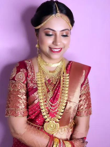 My beautiful bride Pooja, ready for her Pheras. Her South Indian bridal look is complete with traditional gold jewelry, a silk saree, and radiant makeup.