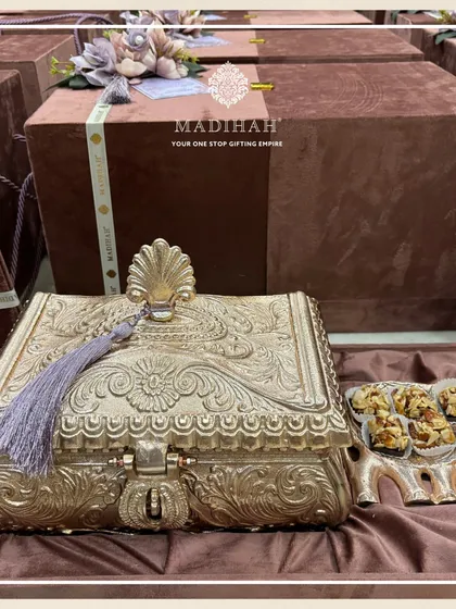 The timeless elegance of our Rajwada Boxes, shown here with an ornate gold-finished chest and an elephant-shaped dry fruit platter. These are versatile pieces perfect for grand wedding announcements or as part of a bridal trousseau.