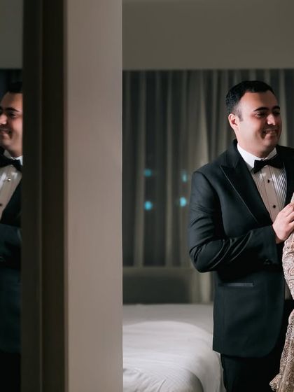 A beautiful reflection shot of the couple, sharing a quiet moment before their reception.