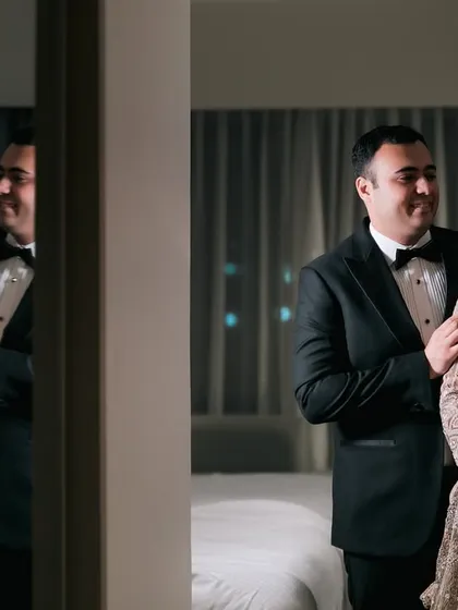 A creative reception portrait using a mirror to reflect the couple's loving gaze.