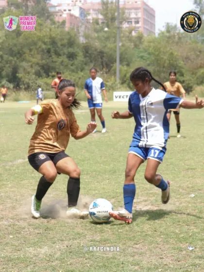Two players locked in a battle for the ball. This image captures the grit and hustle that defines our playing style in the Women's Premier League.