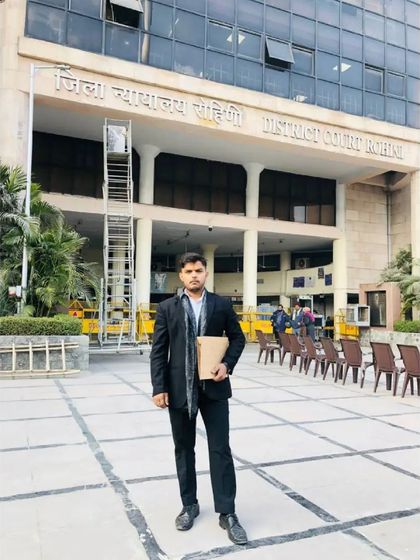 Holding a case file outside the Rohini District Court. If anyone asks, you can tell them I am the lawyer who gets things done.