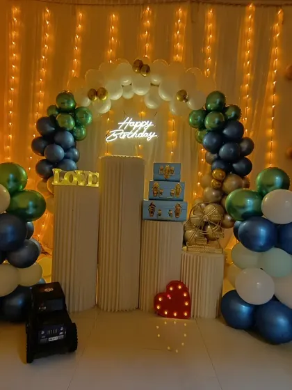 A wide shot of the blue and green birthday party decor, showing how the elements come together to fill the space.