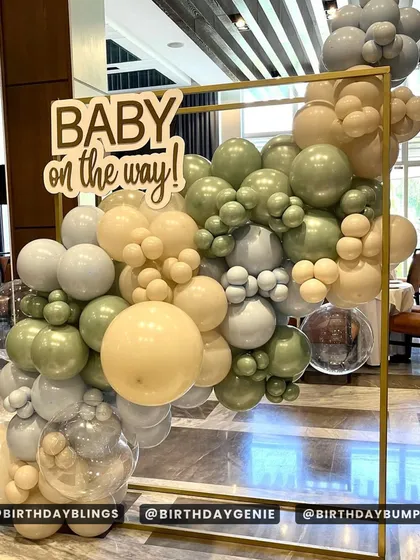 A close-up of the "Baby on the way!" sign and the beautiful, muted balloon colors.