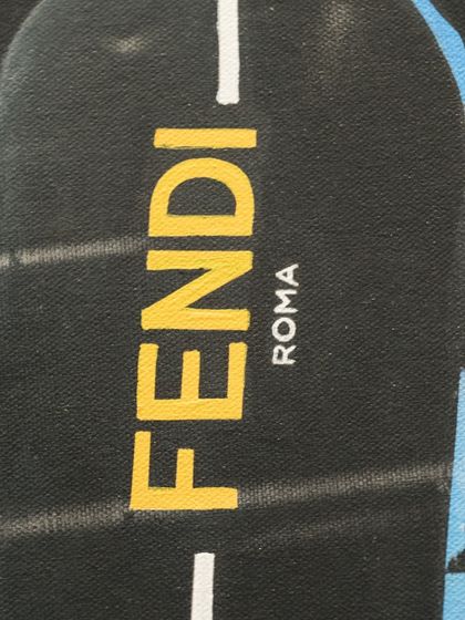 A close-up of the Fendi logo on the snowboard, a key branding element in this luxurious reimagining of a classic masterpiece.