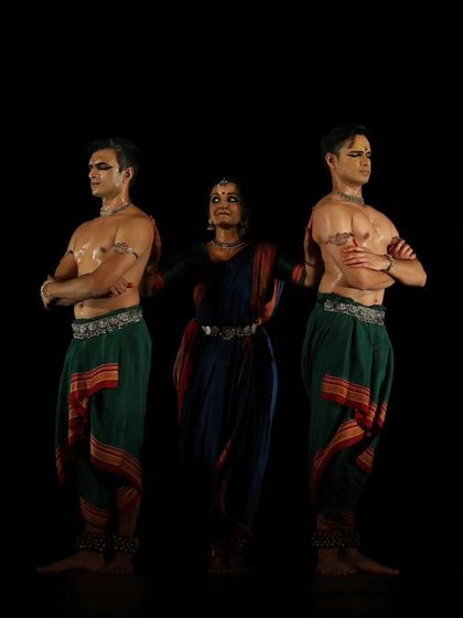 A strong, symmetrical pose from the 'Nagamandala' trio. This kind of formation provides a sense of stability and power on stage.