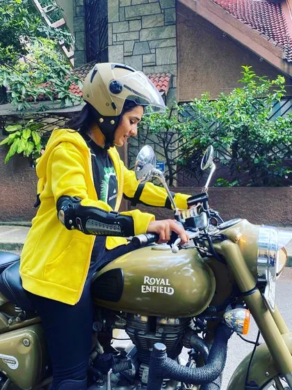 A graduate in a bright yellow jacket, ready to ride. Her confidence and style are an inspiration.