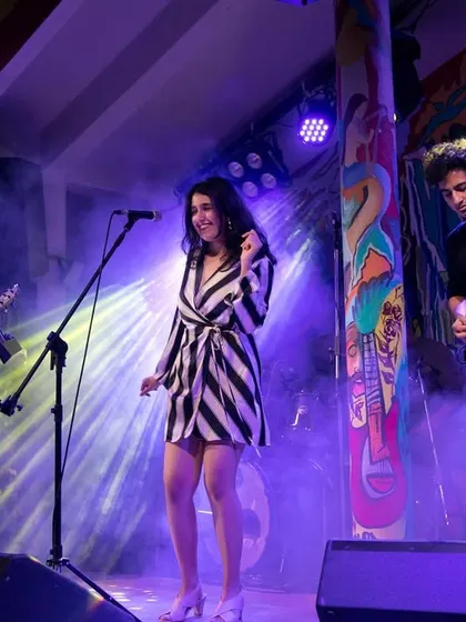 A wide shot of the band during a performance. We ensure a professional setup with high-quality sound and lighting for every show.