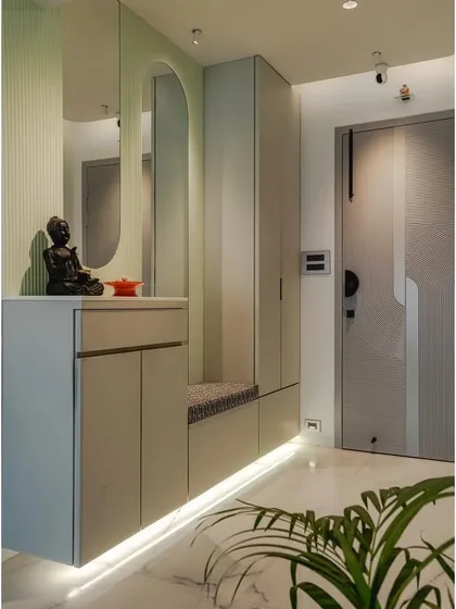 First impressions matter, which is why I designed this entryway to be both welcoming and highly functional. It features a custom-built unit with a comfortable seating nook for putting on shoes, concealed storage cabinets, and an arched mirror, all highlighted by subtle under-cabinet lighting for a warm glow.