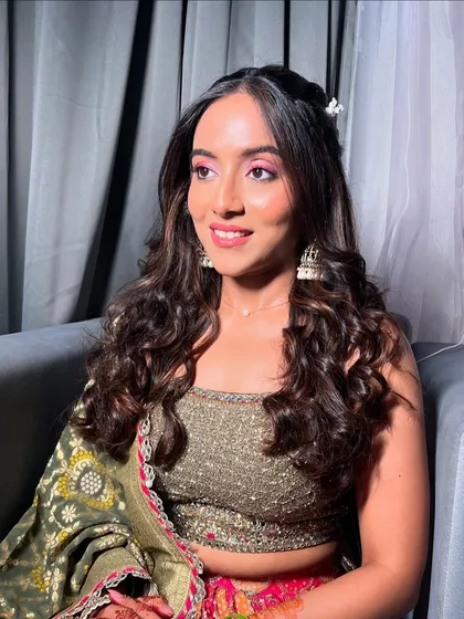 A candid shot of the bride, her makeup looking flawless and her hair perfectly styled in soft waves.