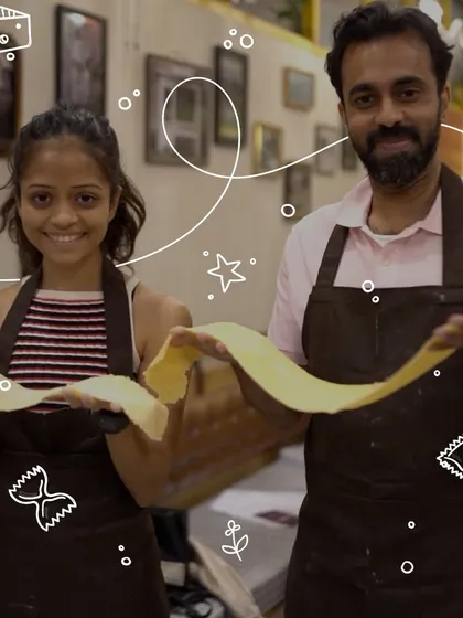 There's nothing quite like the pride of making pasta from scratch. Here, two of our participants proudly display their freshly rolled pasta sheet before turning it into a delicious meal.