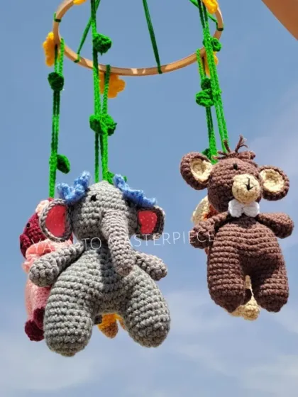 To add a touch of playful charm to a nursery, I design themed cradle mobiles like this jungle animal set. Each little animal has a rattle bell inside to gently engage and soothe your baby.