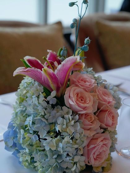 A close-up of a floral centerpiece from the Jimmy Choo event, highlighting the mix of pink lilies, roses, and blue hydrangeas. This level of detail ensures a luxurious feel throughout the venue.
