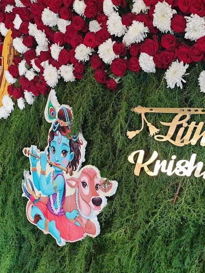 A detailed shot of the Krishna-themed backdrop, focusing on the custom nameplate and the colorful Krishna illustration.