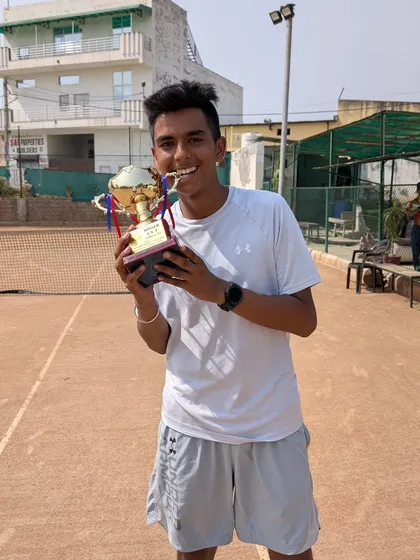 A joyful Arsh Kathuria holding his first U18 AITA Championship Series trophy. This victory is a significant milestone as he prepares for the ITF Junior circuit.
