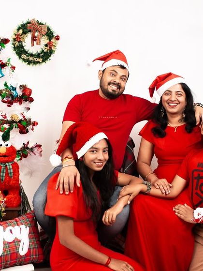 A fun and festive family photo for the holidays. The matching Santa hats and big smiles perfectly capture the spirit of Christmas.