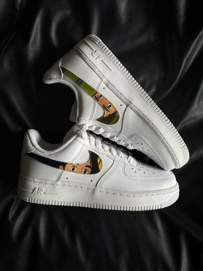 A clean and subtle custom design on Nike Air Force 1s, with a Studio Ghibli character peeking through the swoosh.