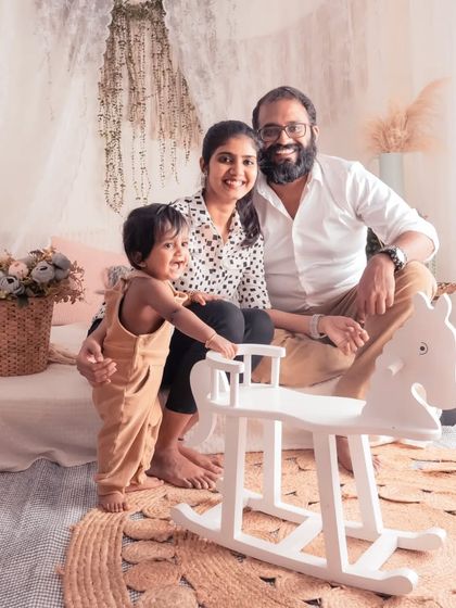 A candid family moment in our lifestyle studio. The little one is so excited about the rocking horse, and his parents' happy expressions complete this perfect family picture.
