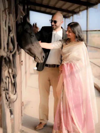 Another sweet moment from the pre-wedding shoot at the stable. The couple's gentle interaction with the horse creates a warm and memorable photograph.