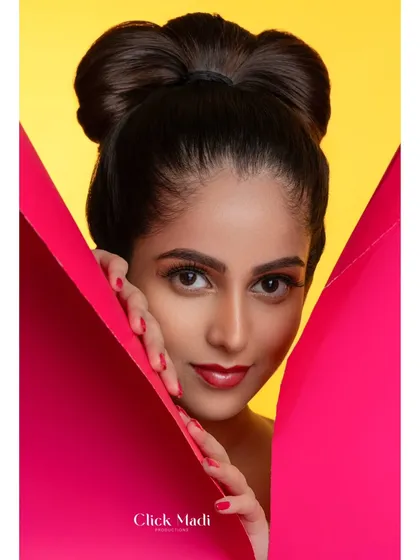 A great portfolio shot captures attitude. This close-up from a creative fashion shoot highlights the model's confident expression, complemented by the sharp lines of the prop and the bright yellow background. I focus on these details to ensure your personality shines through in every frame.
