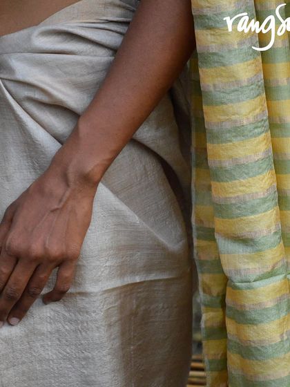 A close-up of the Genda Phool Kosa Silk Saree, showing the striped pallu and the rich texture of the silk. This is a perfect pick for lovers of classic handloom.