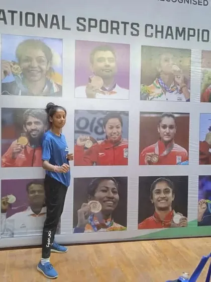 A solo shot of our national bronze medalist, Anjali, in front of the champions' wall.