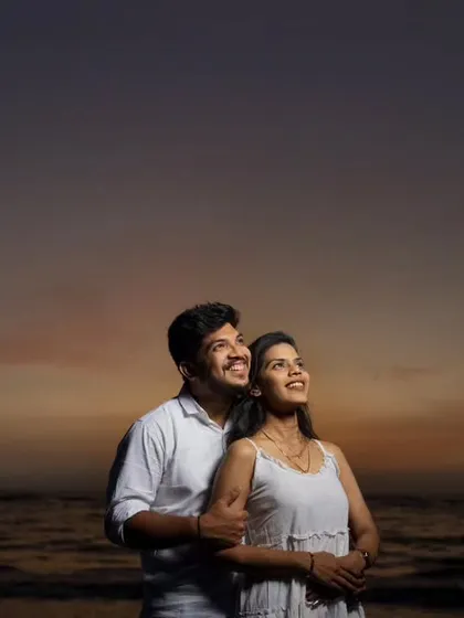 Looking towards the future together. This beautifully composed shot uses the dramatic twilight sky as a canvas, symbolizing the journey the couple is about to embark on.