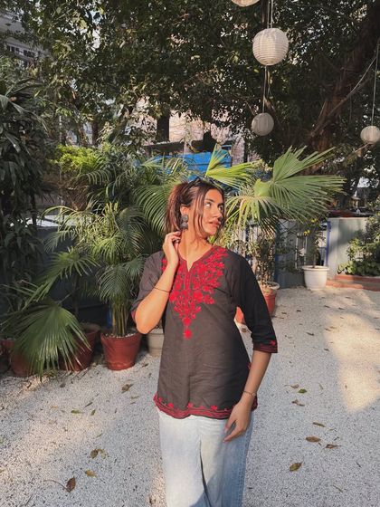 Looking to the side, this shot highlights the beautiful red embroidery on the kurti.