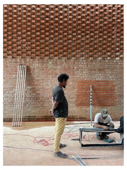 Duplicate of workers installing lighting.