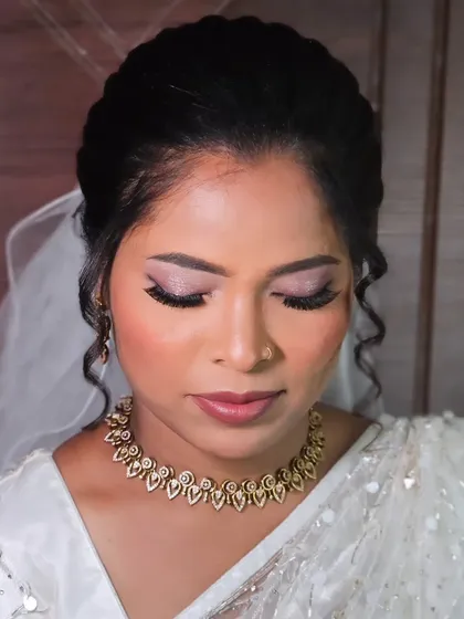 A close-up of a bride's eye makeup for her Christian wedding, with soft pink shimmer and defined lashes.