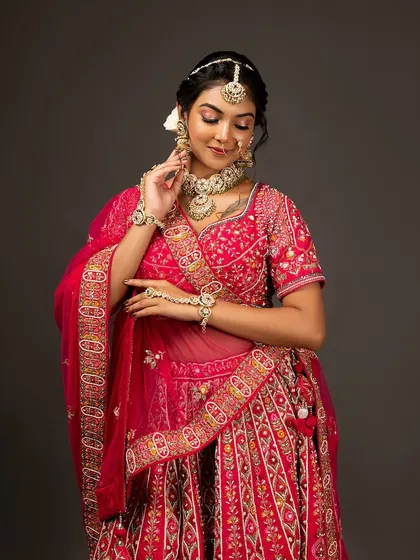 A graceful pose showing the full detail of the embroidered lehenga and dupatta.