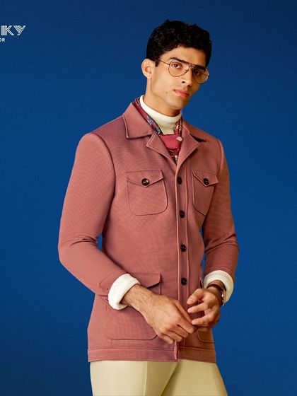 This dusty rose jacket with four front pockets offers a unique blend of utility and style. It is a perfectly crafted piece for a standout, modern look.