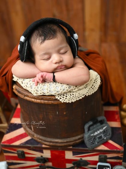 A close-up of our little traveler. The classic 'chin-on-hands' pose is perfect for showing off those chubby cheeks and dreamy expressions.