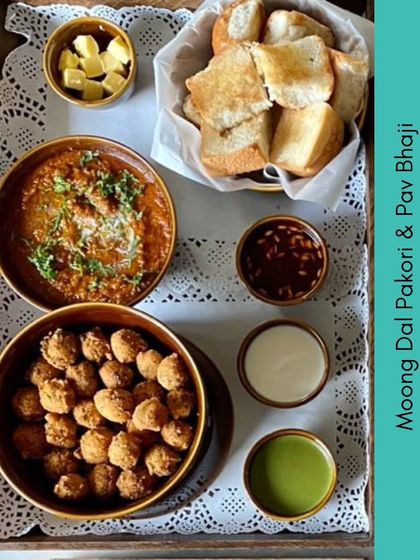 Another delicious Indian platter from our menu. This one includes Moong Dal Pakori and Pav Bhaji, served with an assortment of chutneys, perfect for a hearty and flavorful meal.