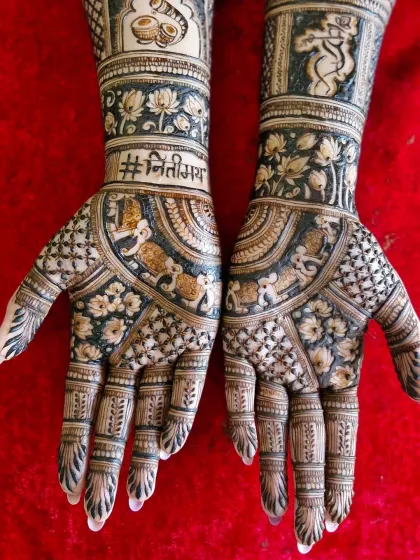 The palm details of the skyline mehendi, featuring the wedding hashtag and traditional elephant motifs, blending modern and classic elements.