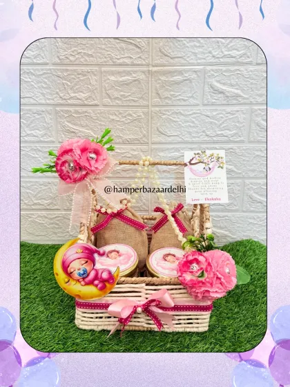 This baby girl announcement hamper in a wicker basket is another one of our budget-friendly yet beautiful designs.