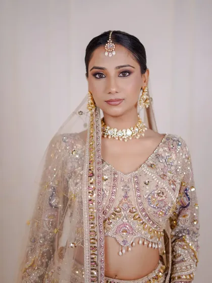 A direct look showing the complete bridal styling with the beige lehenga, perfect for an engagement.