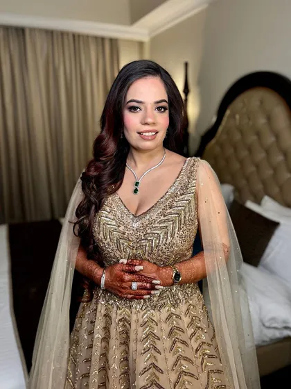 The full look for Ashima's engagement. The makeup perfectly complements her glittering gold gown.