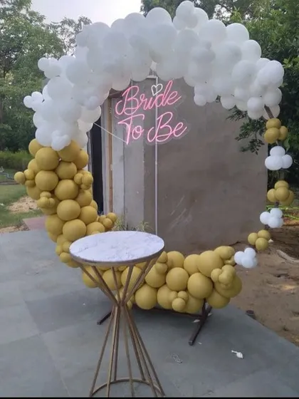 Another angle of the mustard and white balloon ring, showing how the neon "Bride to be" sign glows. This setup is perfect for both indoor and outdoor venues, providing a trendy photo spot.