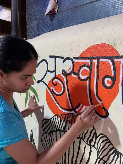 Another angle showing the detailed work on the lettering, ensuring every curve of the script is clean and impactful against the colourful background.